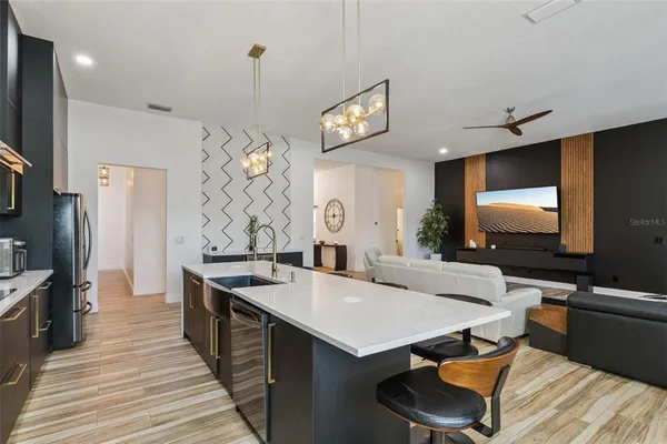 a kitchen with a stove a refrigerator and a sink