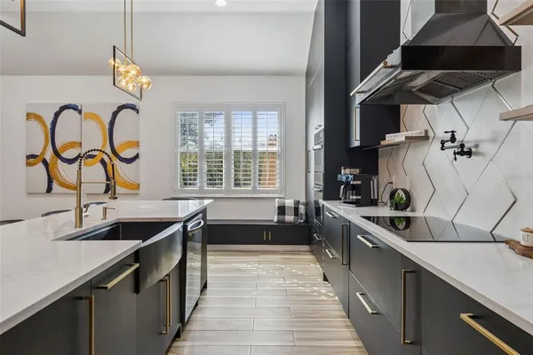 a kitchen with granite countertop a sink and a stove