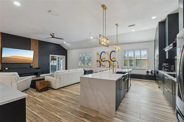 a view of living room kitchen with stainless steel appliances granite countertop living room and living room view