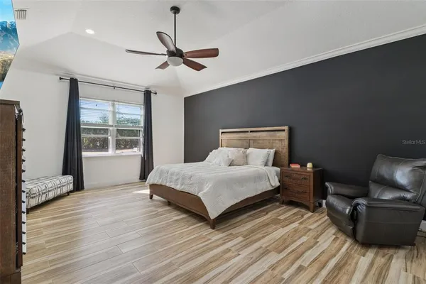 a bedroom with a bed and a chandelier