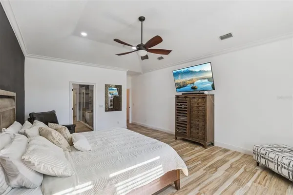 a bedroom with a bed and a flat screen tv