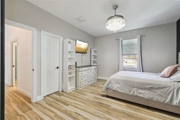 a bedroom with a bed and a desk