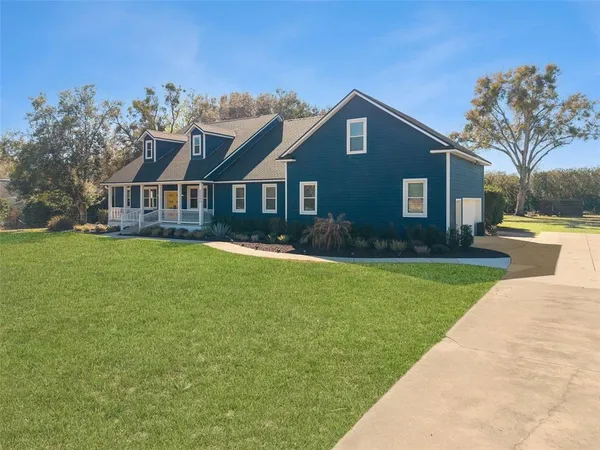 a front view of house with yard and green space