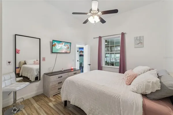 a bedroom with a bed and a flat screen tv