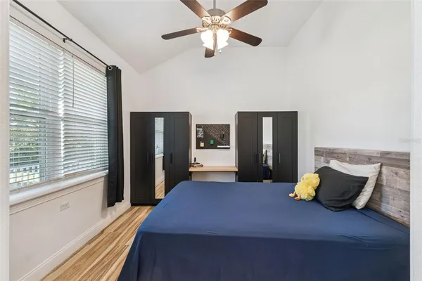 a bedroom with a bed and a large window