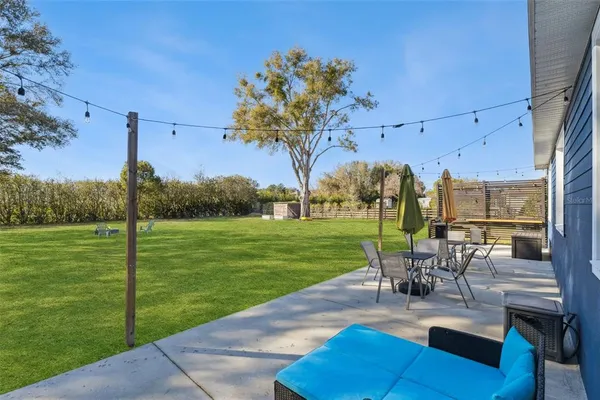 a view of a lake with a table and chairs under an umbrella