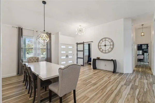 a view of a dining room with furniture window and wooden floor