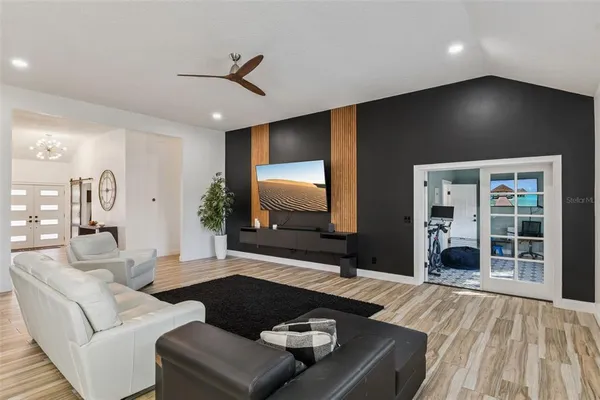 a living room with furniture and a flat screen tv