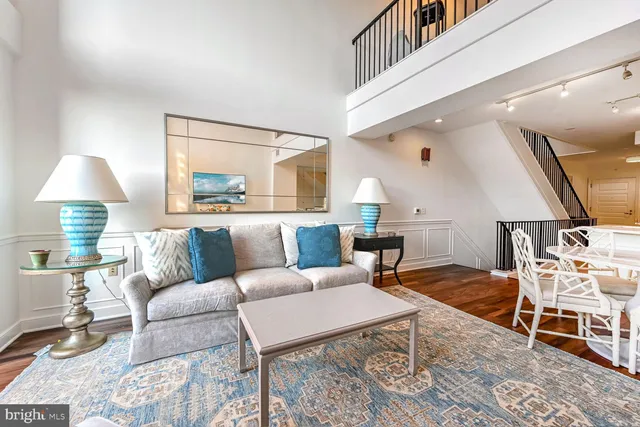 a living room with furniture and a lamp