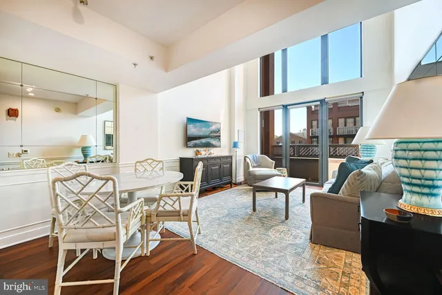 a living room with furniture a flat screen tv and a table