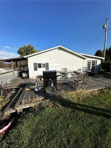 a view of a house with backyard and sitting area