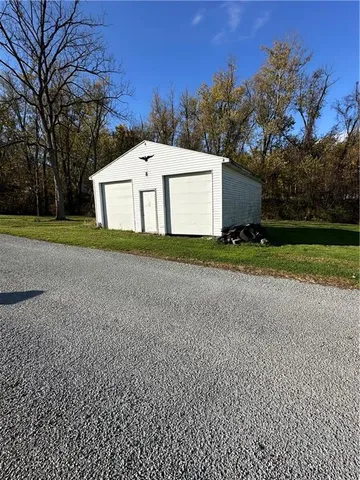a view of a house with a yard and garage