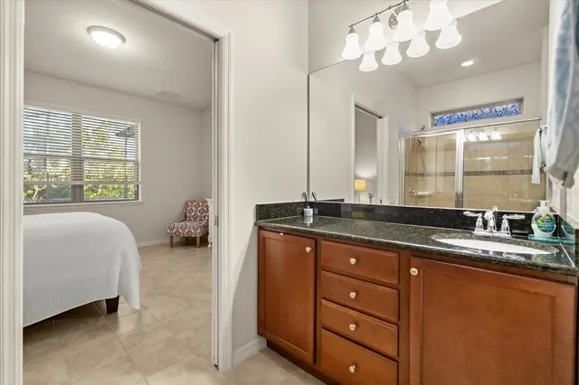 a bath room with a sink double vanity and a mirror