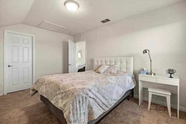 a bedroom with a bed and a table