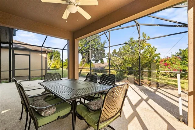 a dining room with furniture a chandelier and wooden floor