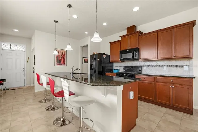 a kitchen with stainless steel appliances granite countertop a sink wooden cabinets and a granite counter tops