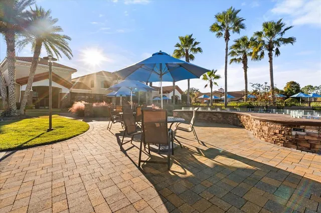 a view of a swimming pool with a table and chairs