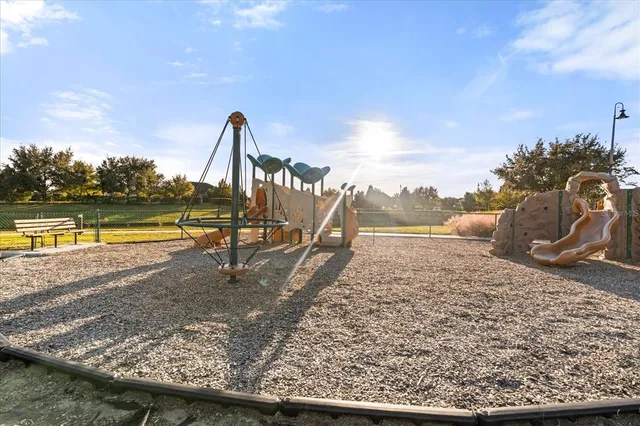 a view of a swimming pool with a lake and trees in the background