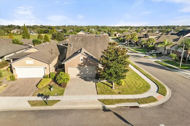 an aerial view of residential houses with outdoor space and ocean view