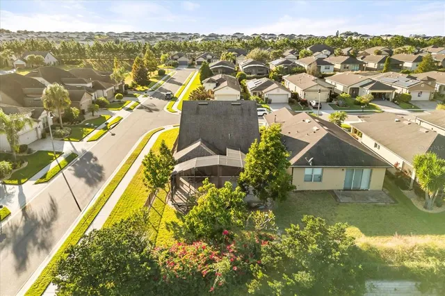 an aerial view of residential houses with outdoor space and swimming pool