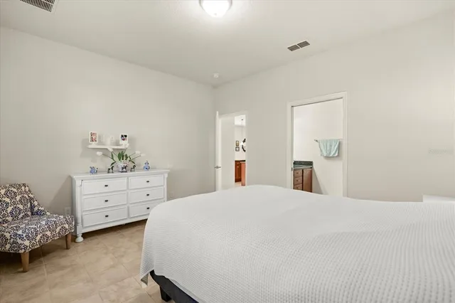 a bedroom with a bed and a dresser