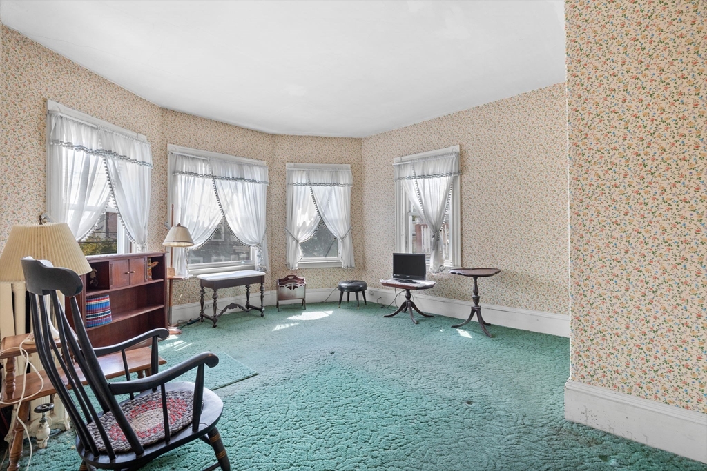 44 Walnut Street Everett, MA 02149 - Photo 22 of 38 a living room with furniture and a floor to ceiling window