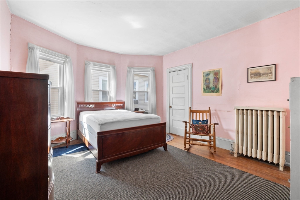 44 Walnut Street Everett, MA 02149 - Photo 26 of 38 a spacious bedroom with a bed and a window