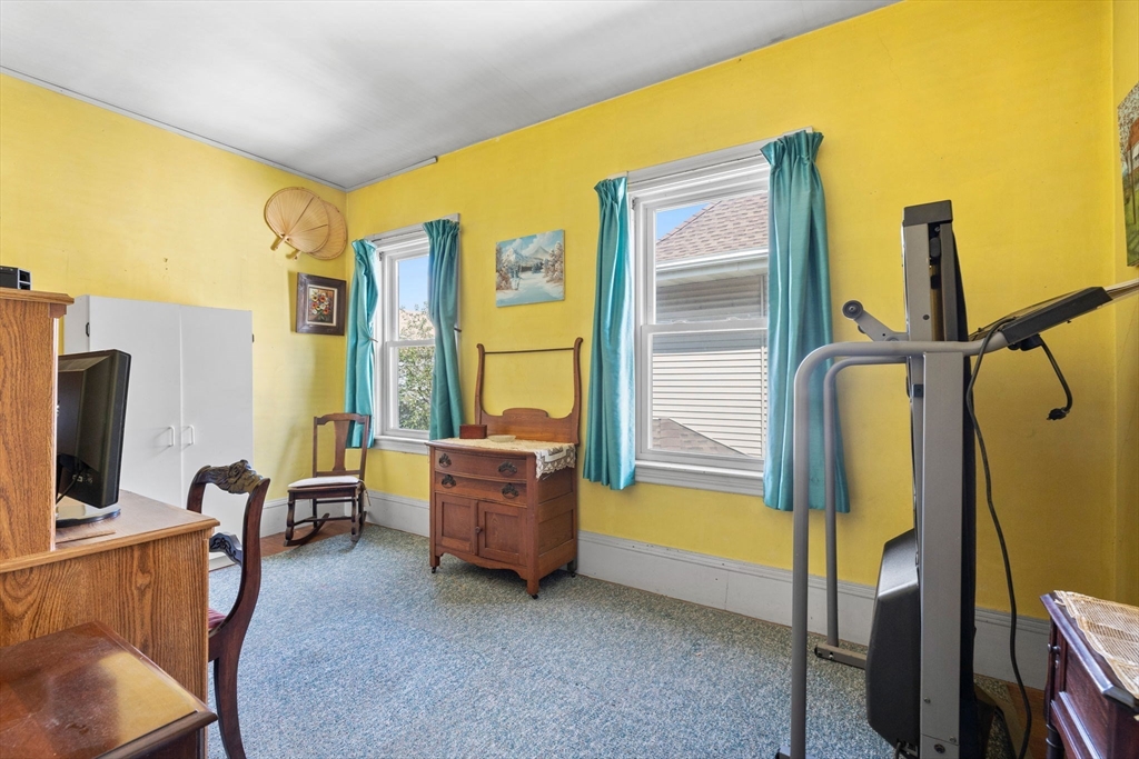 44 Walnut Street Everett, MA 02149 - Photo 27 of 38 a living room with furniture pool table and a flat screen tv