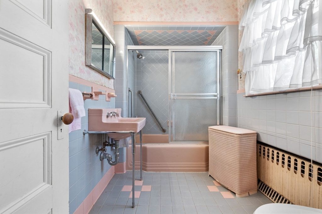 44 Walnut Street Everett, MA 02149 - Photo 28 of 38 a bath room with a sink a mirror and a window