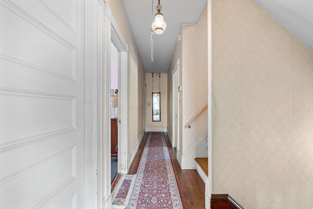 44 Walnut Street Everett, MA 02149 - Photo 30 of 38 a view of a hallway with wooden floor and staircase