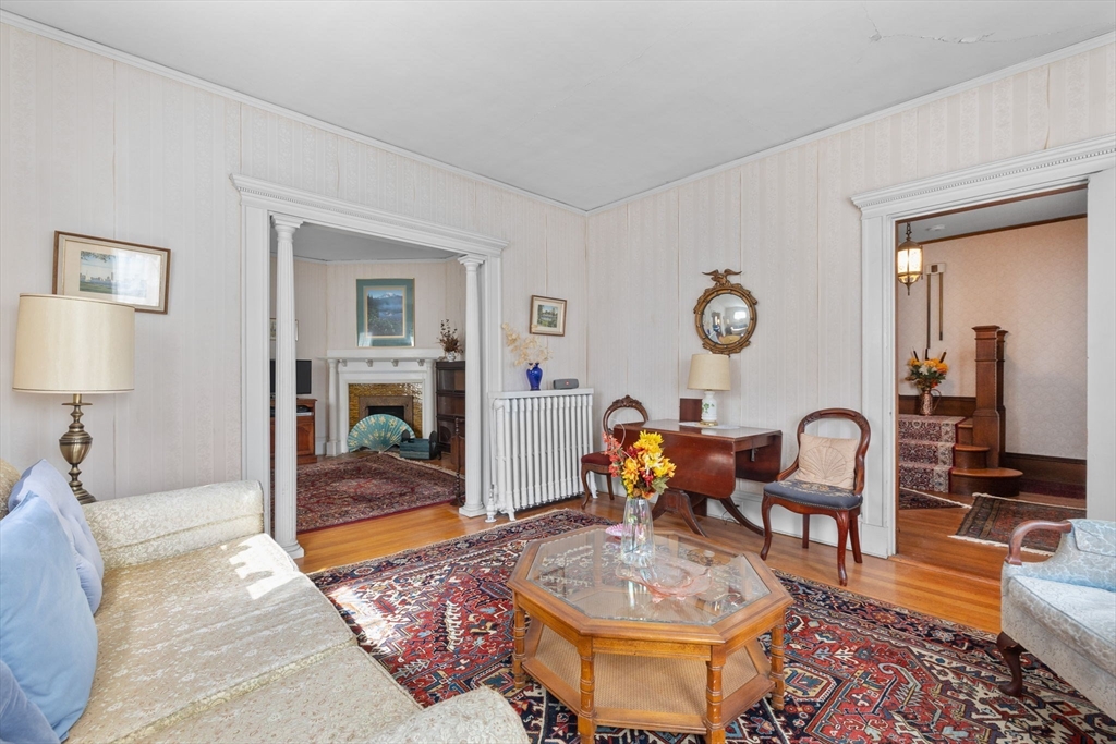44 Walnut Street Everett, MA 02149 - Photo 7 of 38 a living room with furniture a rug and a mirror