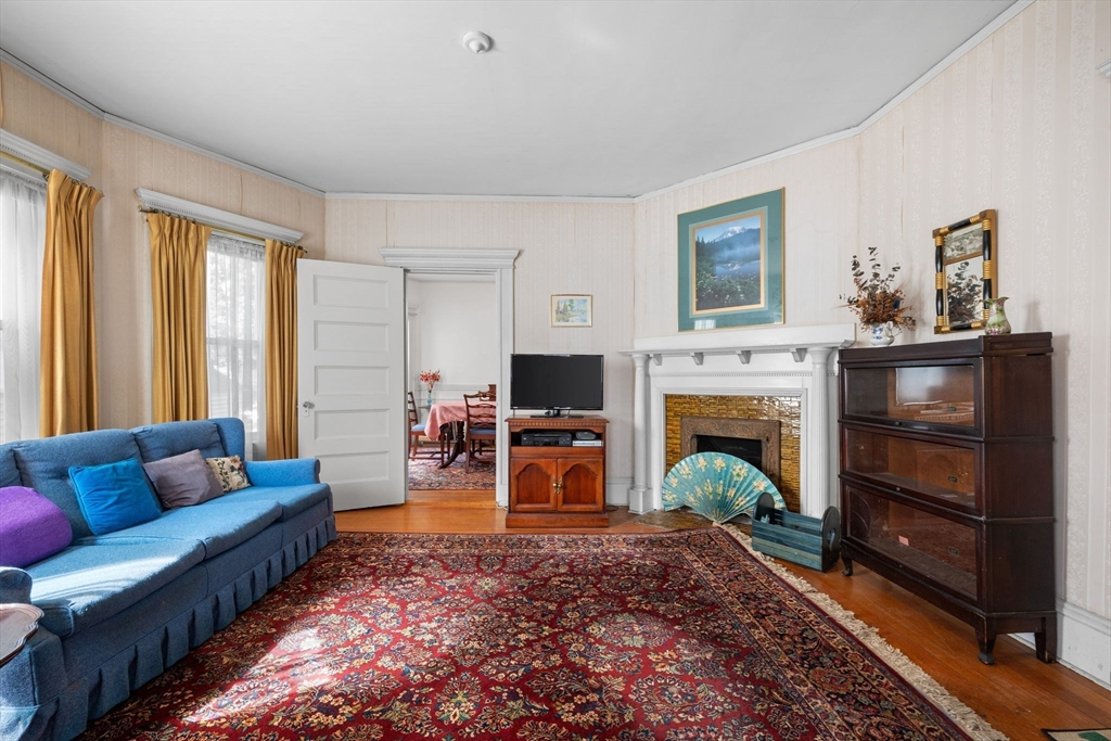 44 Walnut Street Everett, MA 02149 - Photo 9 of 38 a living room with furniture and a fireplace