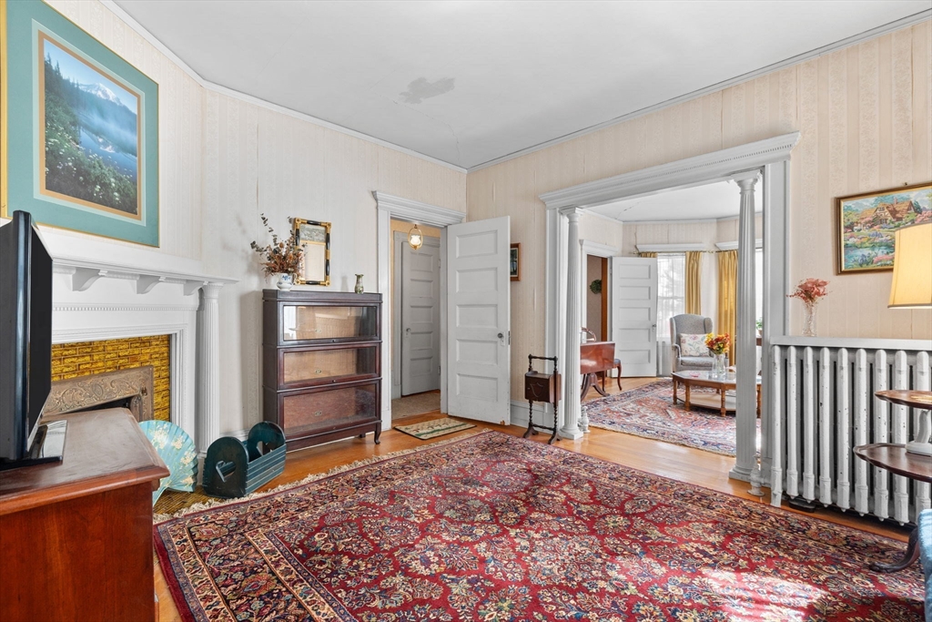 44 Walnut Street Everett, MA 02149 - Photo 10 of 38 a bedroom with a bed and a flat screen tv