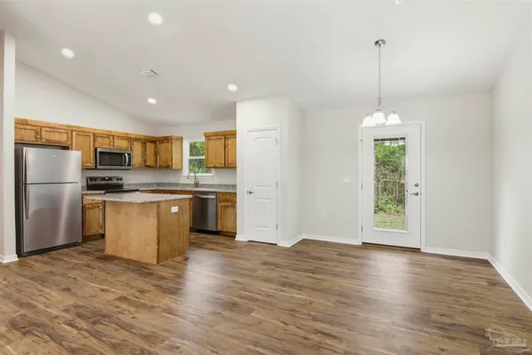 a kitchen with a refrigerator and white cabinets