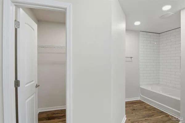 a view of bathroom with a sink and mirror with toilet