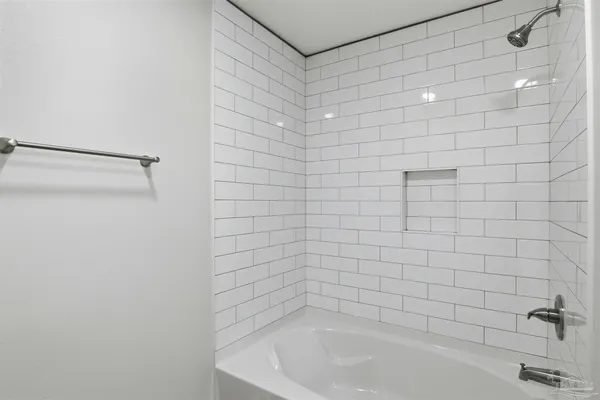 a bathroom with a granite countertop sink a toilet and shower