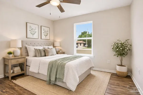 a bedroom with bed and a chandelier