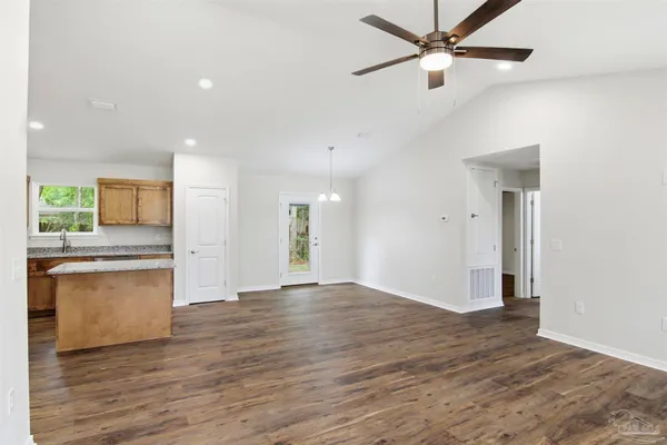a view of a kitchen with a sink and a stove top oven
