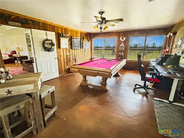 a room with patio furniture and a flat screen tv