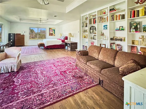 a living room with furniture and a book shelf