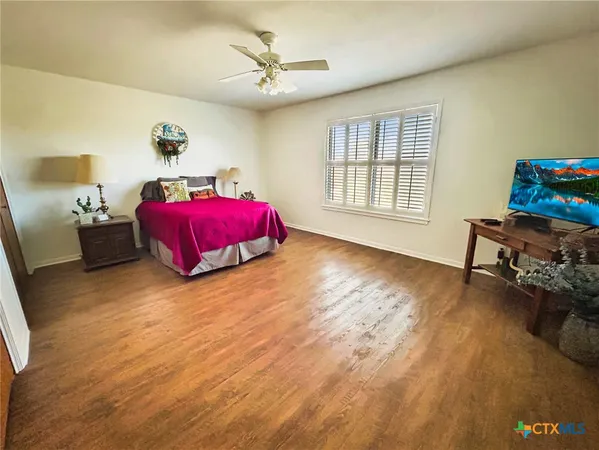 a spacious bedroom with a bed and a chandelier