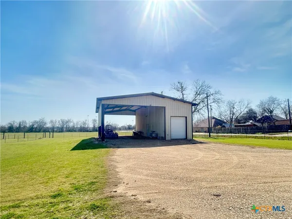 a view of a swimming pool with an outdoor seating and a yard