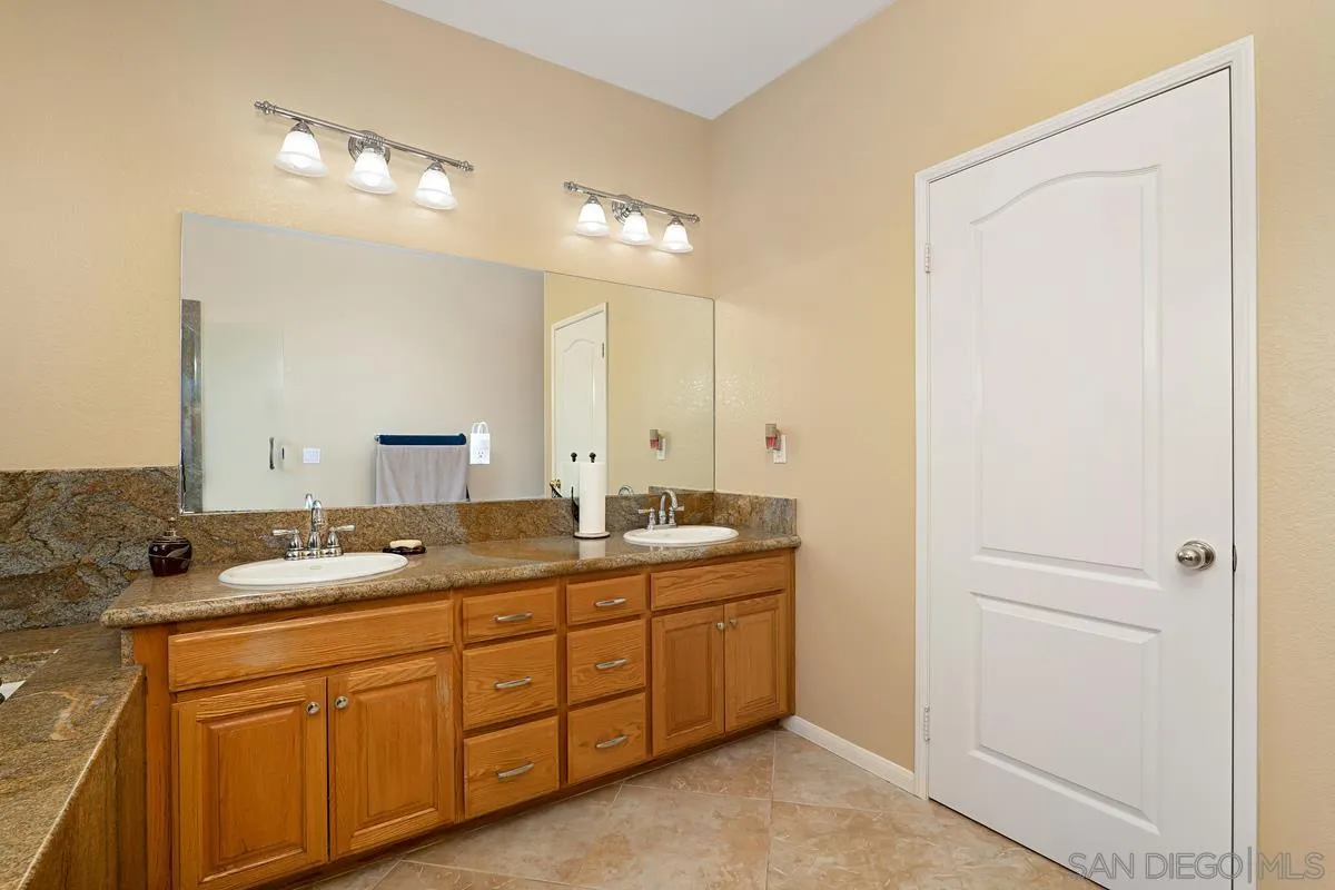 1707 Horizon Heights Circle El Cajon, CA 92019 - Photo 13 of 26 a bathroom with a granite countertop sink mirror and double