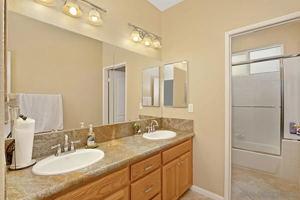 1707 Horizon Heights Circle El Cajon, CA 92019 - Photo 18 of 26 a bathroom with a granite countertop sink mirror and double