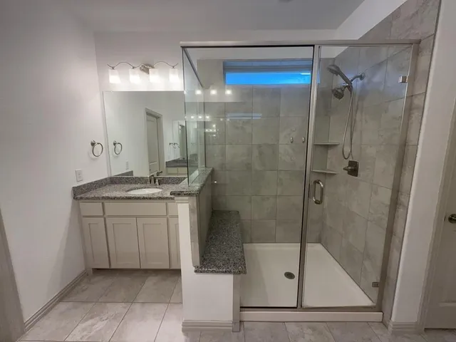 a white toilet sitting next to a white wall