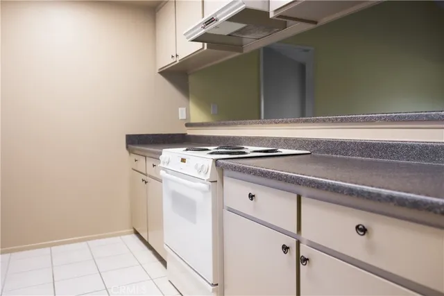 a sink with white cabinets