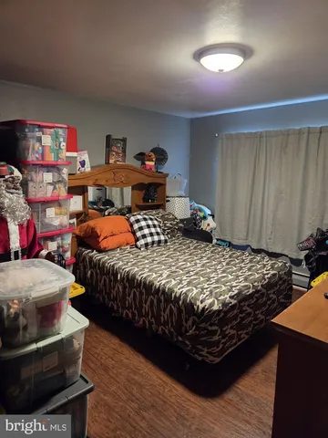 a bedroom with a bed and a dresser in it