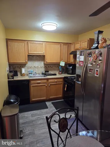 a kitchen with a sink appliances and cabinets