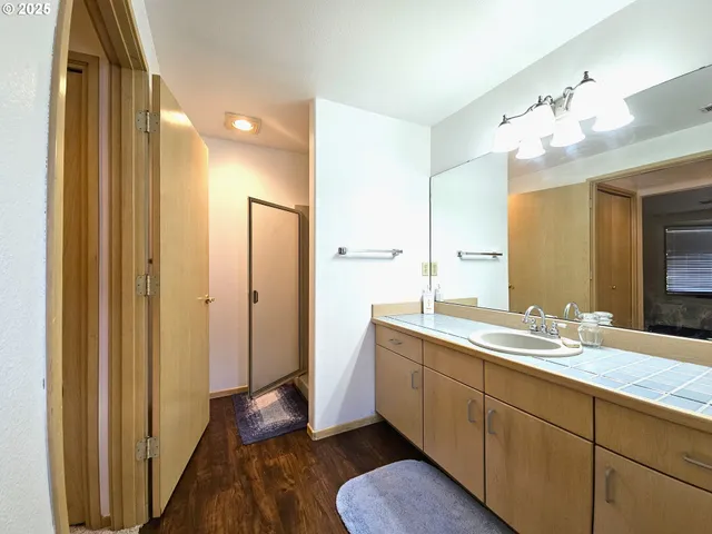 a view of a hallway with stairs and chandelier