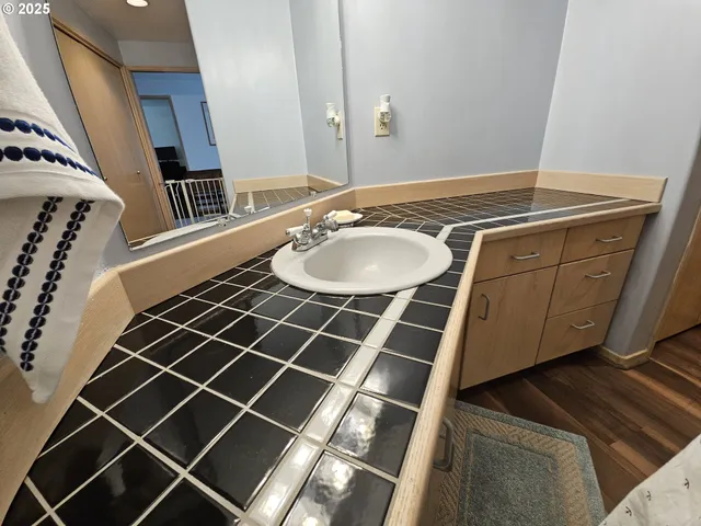 a view of a house with a big yard and large trees